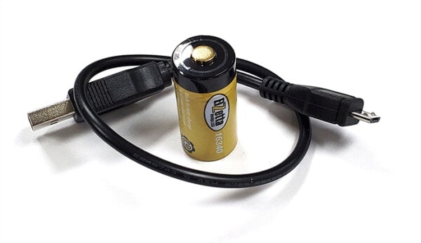 Elzetta brand 16340 (RCR123 rechargeable battery cell) with USB port and charging cable. White Background.