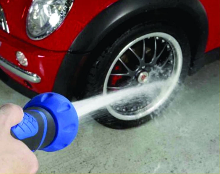 Garden hose spraying narrow spray of water representing high candela