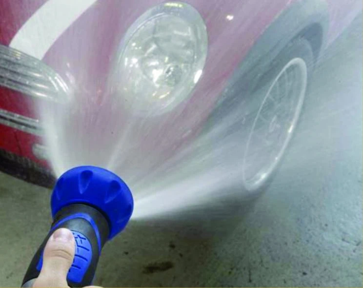 Garden hose spraying a wide spray of water representing low candela.