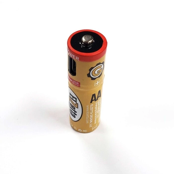 Elzetta brand rechargeable AA battery with USB Port standing vertically on white surface.