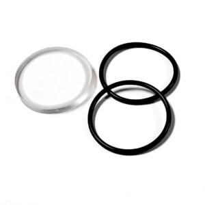HC Head Lens Cover Kit. Lens and two O-Rings Lying on White Surface