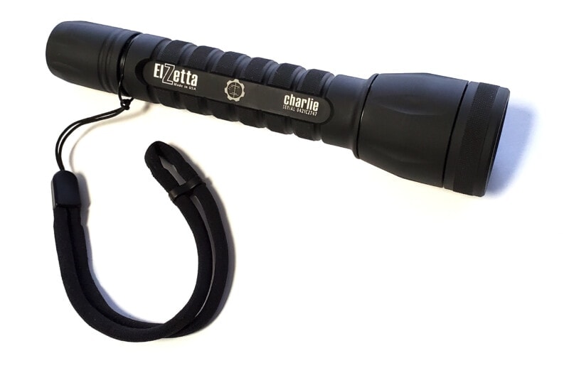 Elzetta Charlie C133 Flashlight with Lanyard Ring Installed with Lanyard Lying Next to the Light. White background